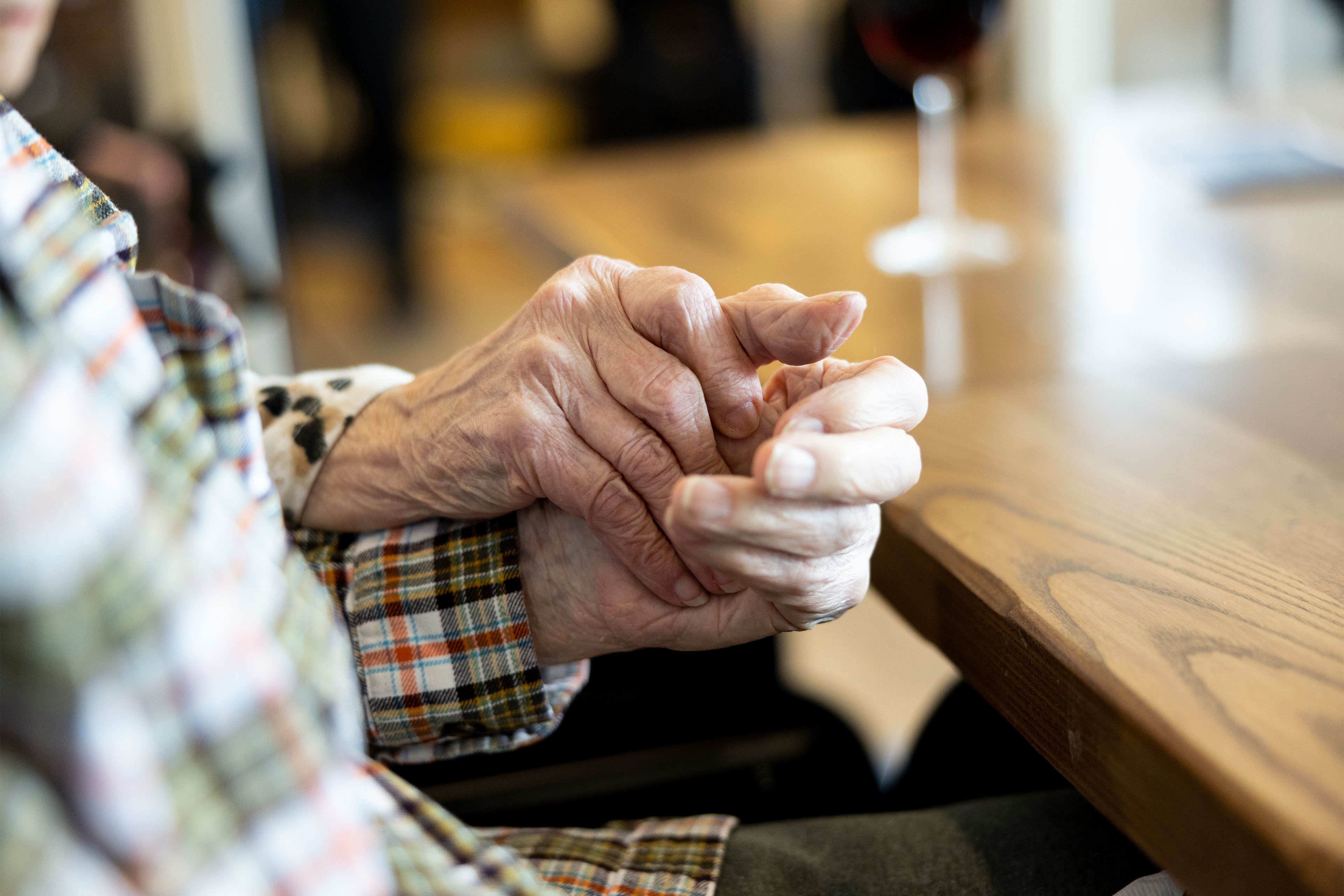 A photo of an elderly couple holding hands.