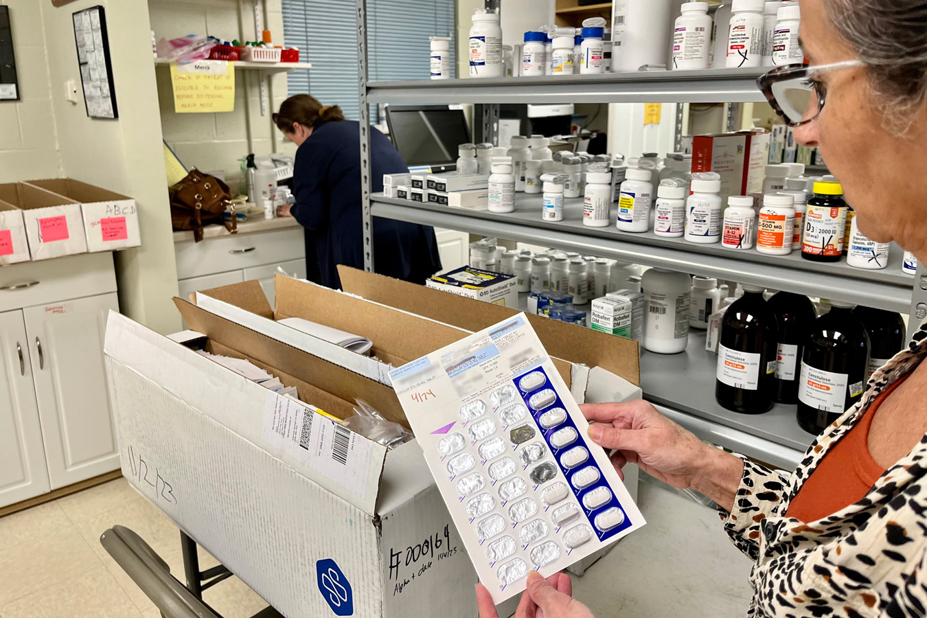 Pharmacist Frieda Martin holds a donated medication blister pack at Open Bible Clinic and Pharmacy in Colorado Springs, Colorado, on Nov. 7, 2023.